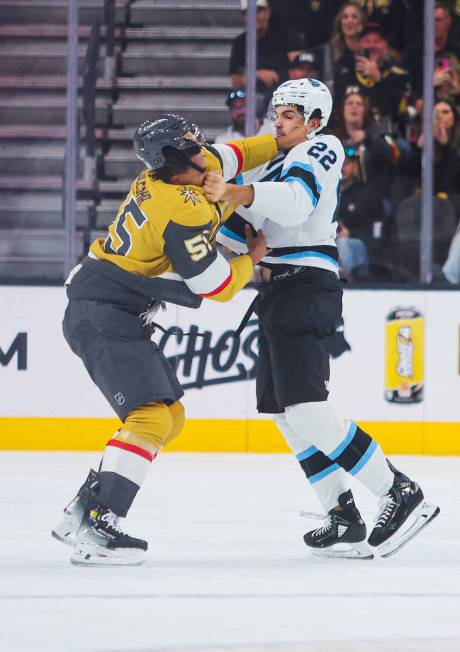 Golden Knights right wing Keegan Kolesar (55) throws a punch at Utah Hockey Club center Jack Mc ...