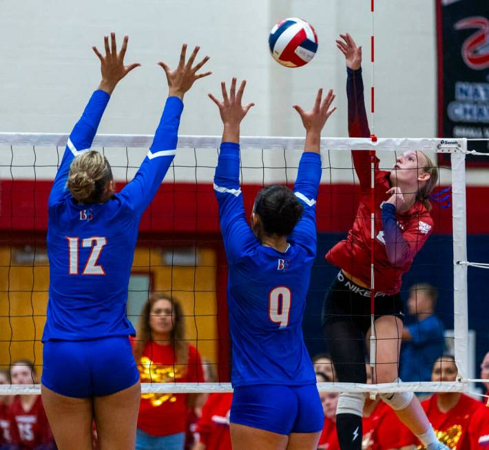 Coronado's Julie Beckham (2) spikes the ball as Bishop Gorman's Brooklynn Williams (12) and Tr ...