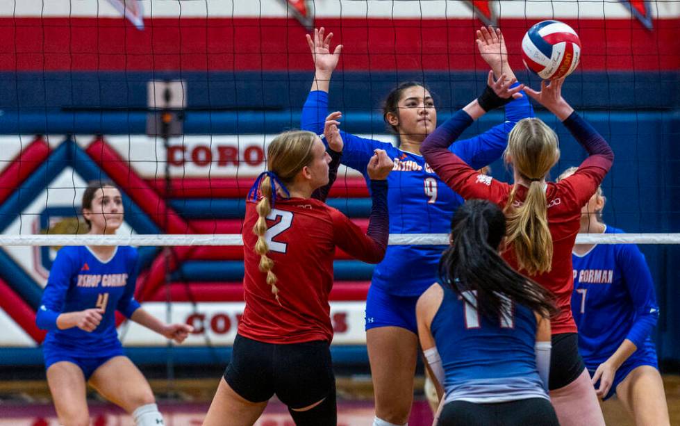 Bishop Gorman's Trinity Thompson (9) looks to defend a return by Coronado's Hannah Wayment (1) ...