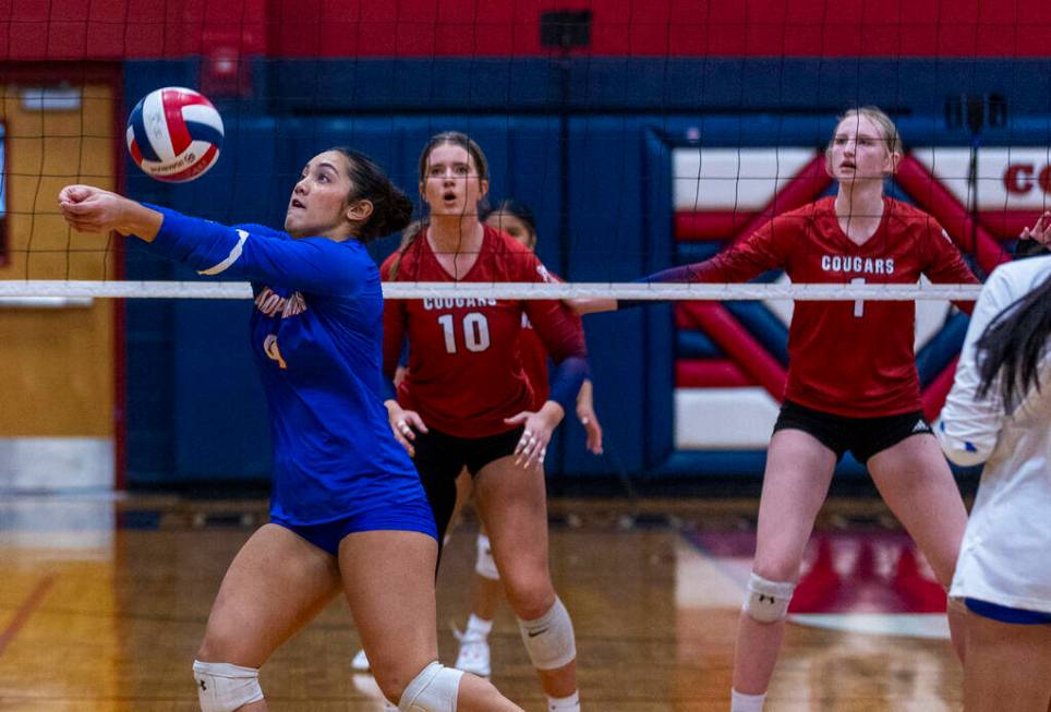 Bishop Gorman's Trinity Thompson (9) digs out a shot as Coronado's Rachel Schwartz (10) and Han ...