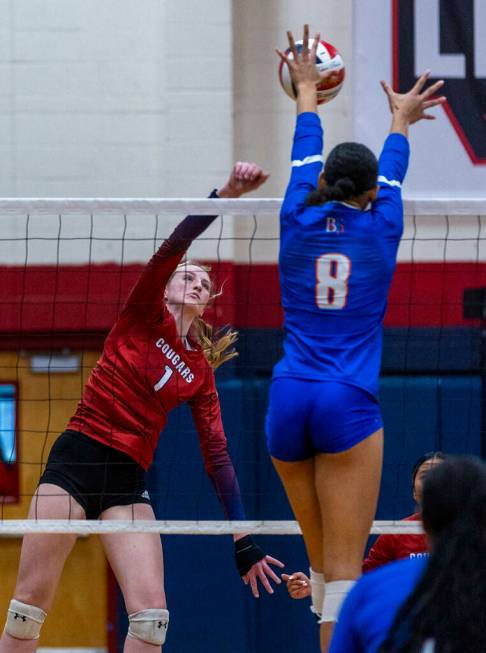 Coronado's Hannah Wayment (1) spikes the ball as Bishop Gorman's Ayanna Watson (8) goes up high ...