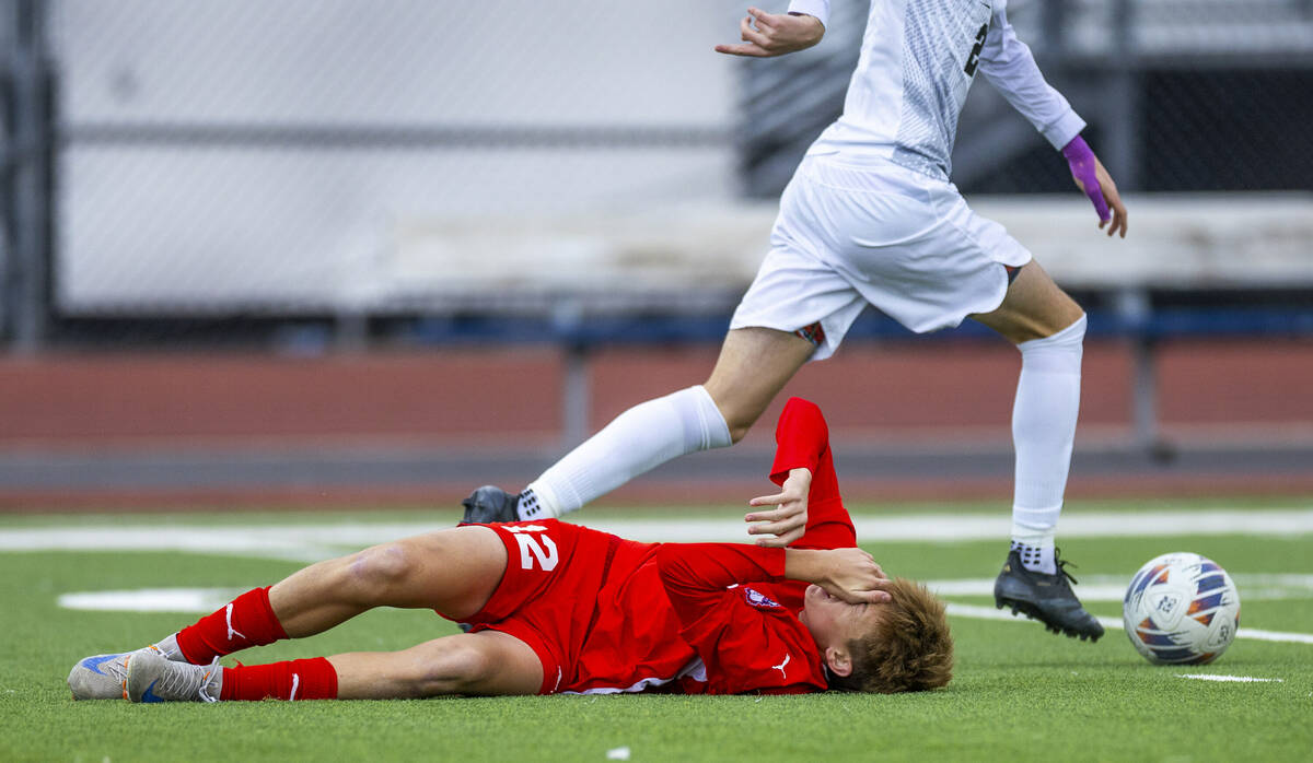 Coronado midfielder Liam Bringhurst (12) is down after a collision with Palo Verde defender Jax ...