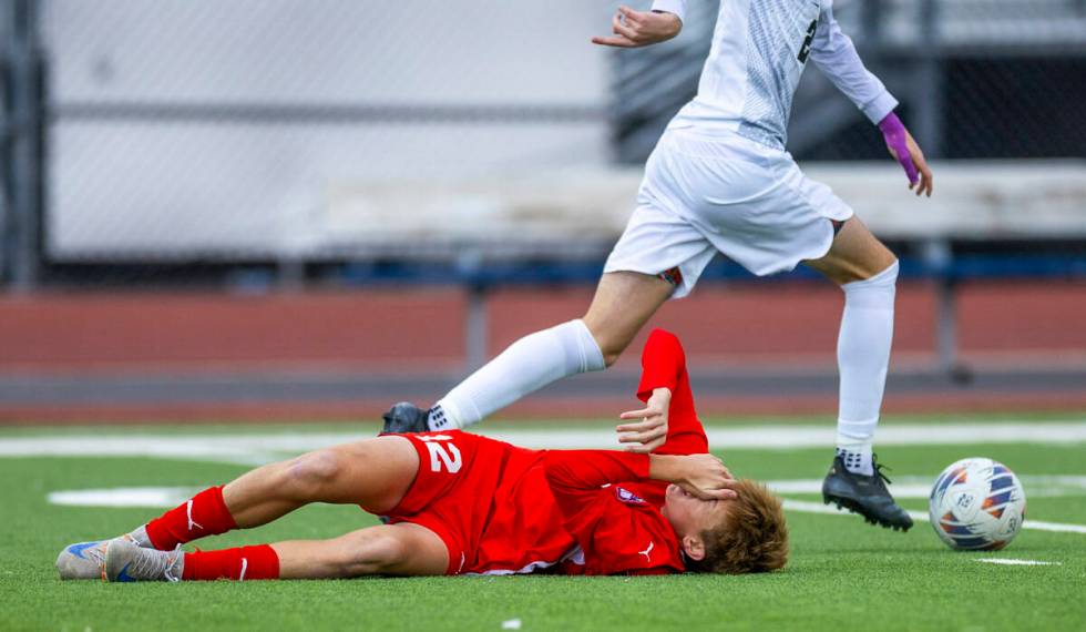 Coronado midfielder Liam Bringhurst (12) is down after a collision with Palo Verde defender Jax ...