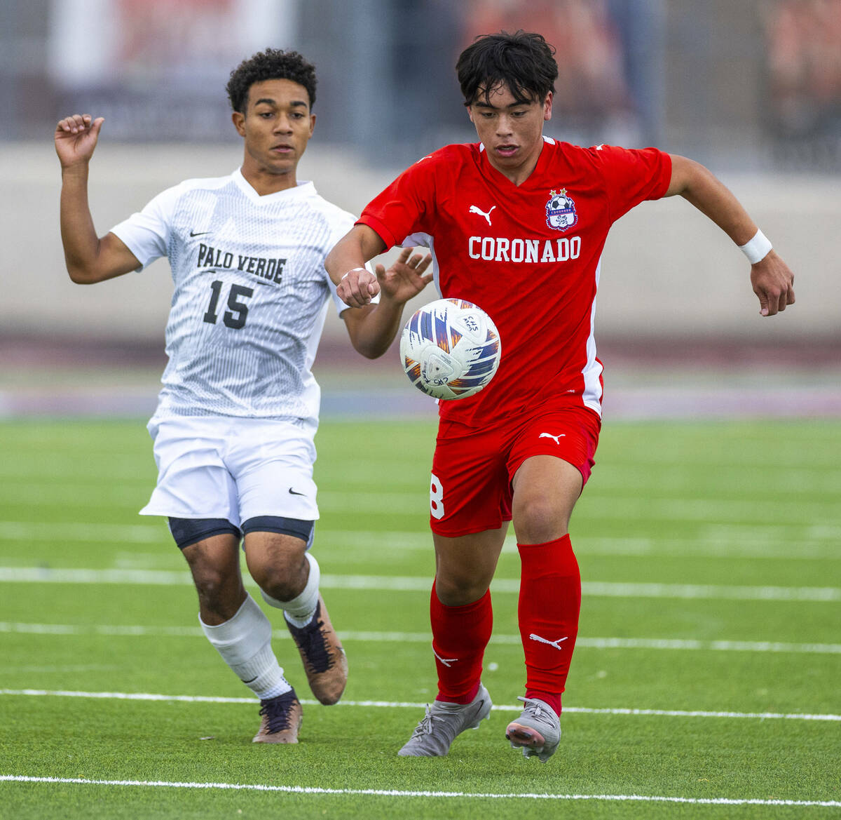 Coronado midfielder Cy Adams (8) advances the ball pursued by Palo Verde forward Trevon Aytch ( ...