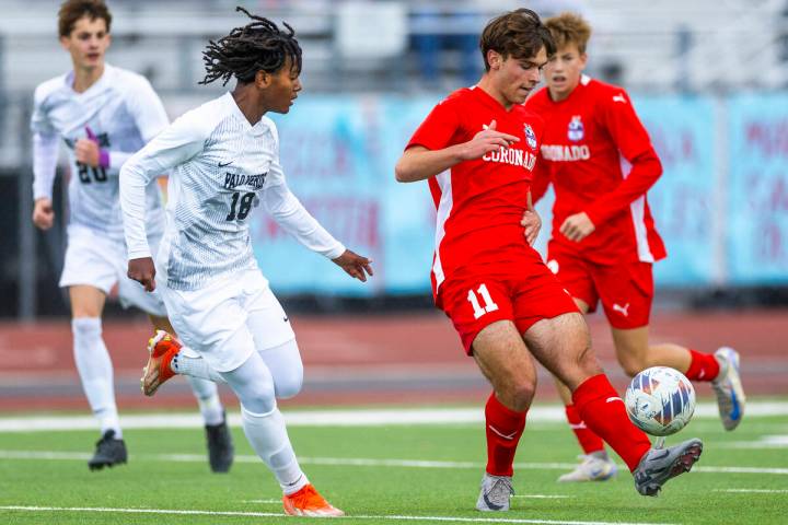 Coronado striker Gavin Flickinger (11) kicks the ball past Palo Verde halfback Shilo Stephenson ...