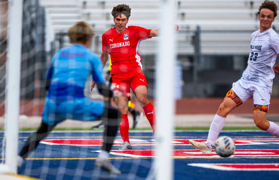 Coronado striker Gavin Flickinger (11) sends a pass away from Palo Verde defender Ben Legrand ( ...