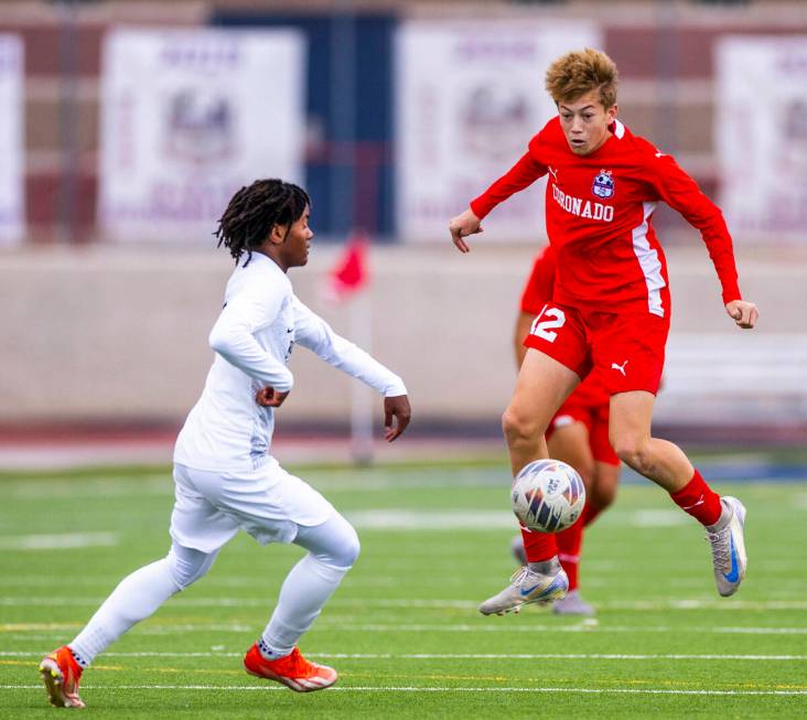 Coronado midfielder Liam Bringhurst (12) heads a ball down as Palo Verde halfback Shilo Stephen ...