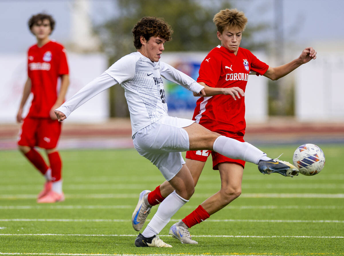 Palo Verde midfielder Trustin Parker (22) kicks the ball past Coronado midfielder Liam Bringhur ...