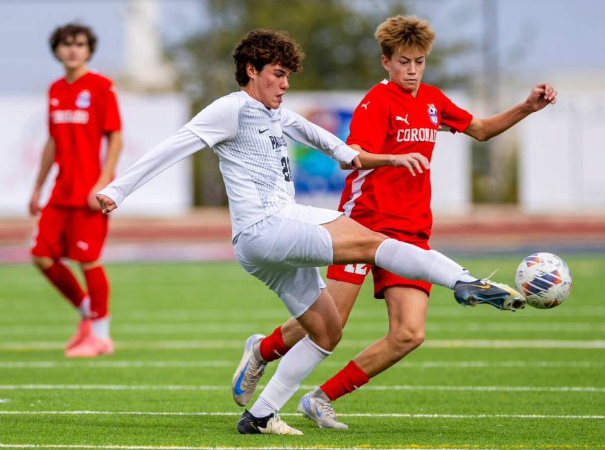 Palo Verde midfielder Trustin Parker (22) kicks the ball past Coronado midfielder Liam Bringhur ...