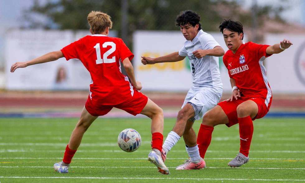 Coronado midfielder Liam Bringhurst (12) challenges Palo Verde wing back Cruz Carranza (6) as ...