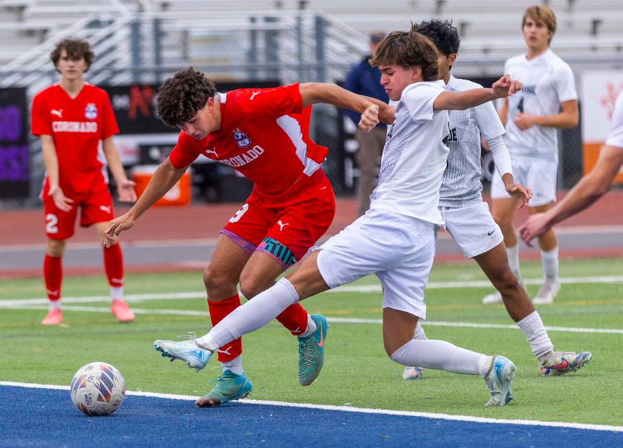 Coronado striker Dylan Flores (9) battles past Palo Verde forward Luke Knecht (4) for another ...