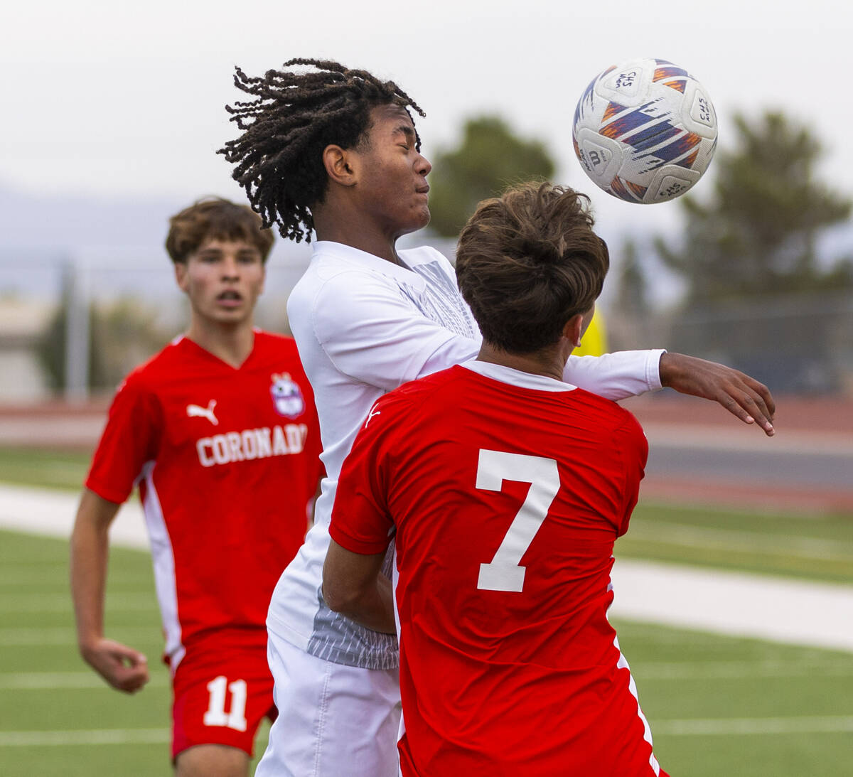 Palo Verde halfback Shilo Stephenson (18) heads the ball away from Coronado forward Austin Kier ...