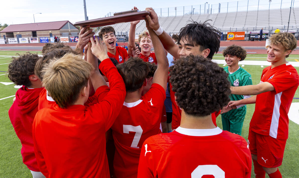 Coronado players celebrate their 3-0 win over Palo Verde with a trophy following their Class 5A ...