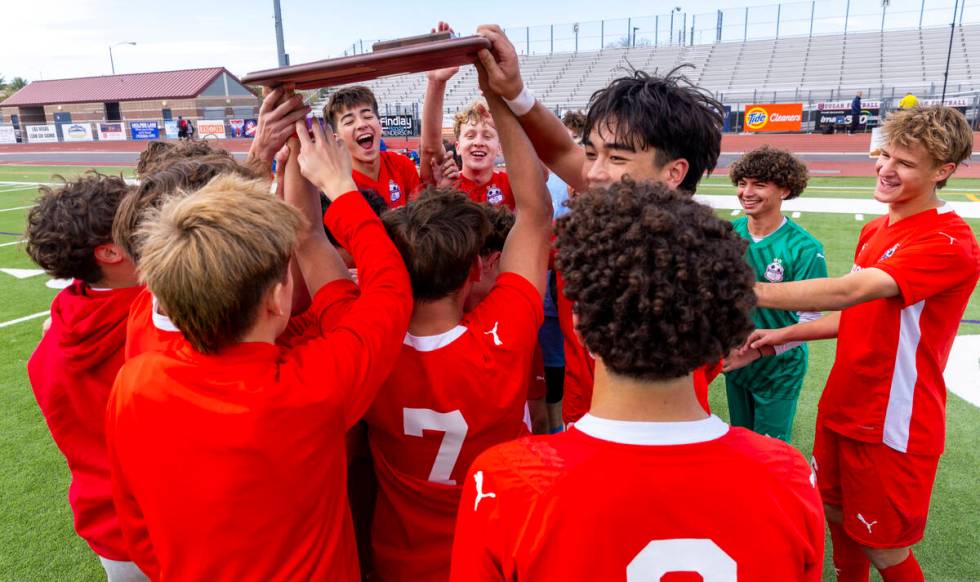 Coronado players celebrate their 3-0 win over Palo Verde with a trophy following their Class 5A ...