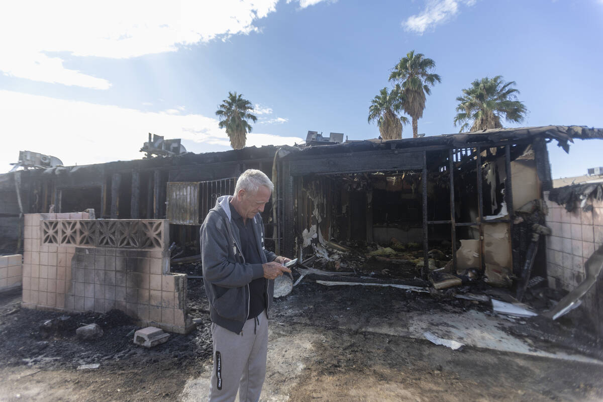 Paradise Spa homeowners association president Dennis Snapp stands outside an apartment that bur ...