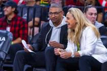 Aces head coach Becky Hammon laughs on the bench with assistant coach Tyler Marsh against ...