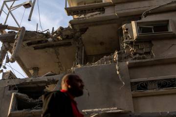 A man looks at damaged building after projectiles fired from Lebanon hit a home in Tira, centra ...