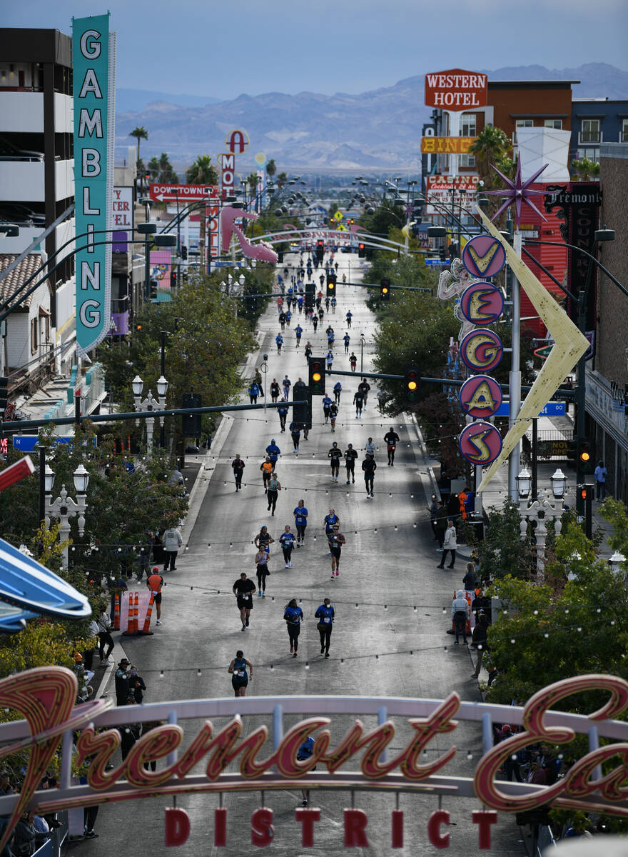 Participants head towards the finish line on Fremont Street during the Las Vegas Marathon Sunda ...