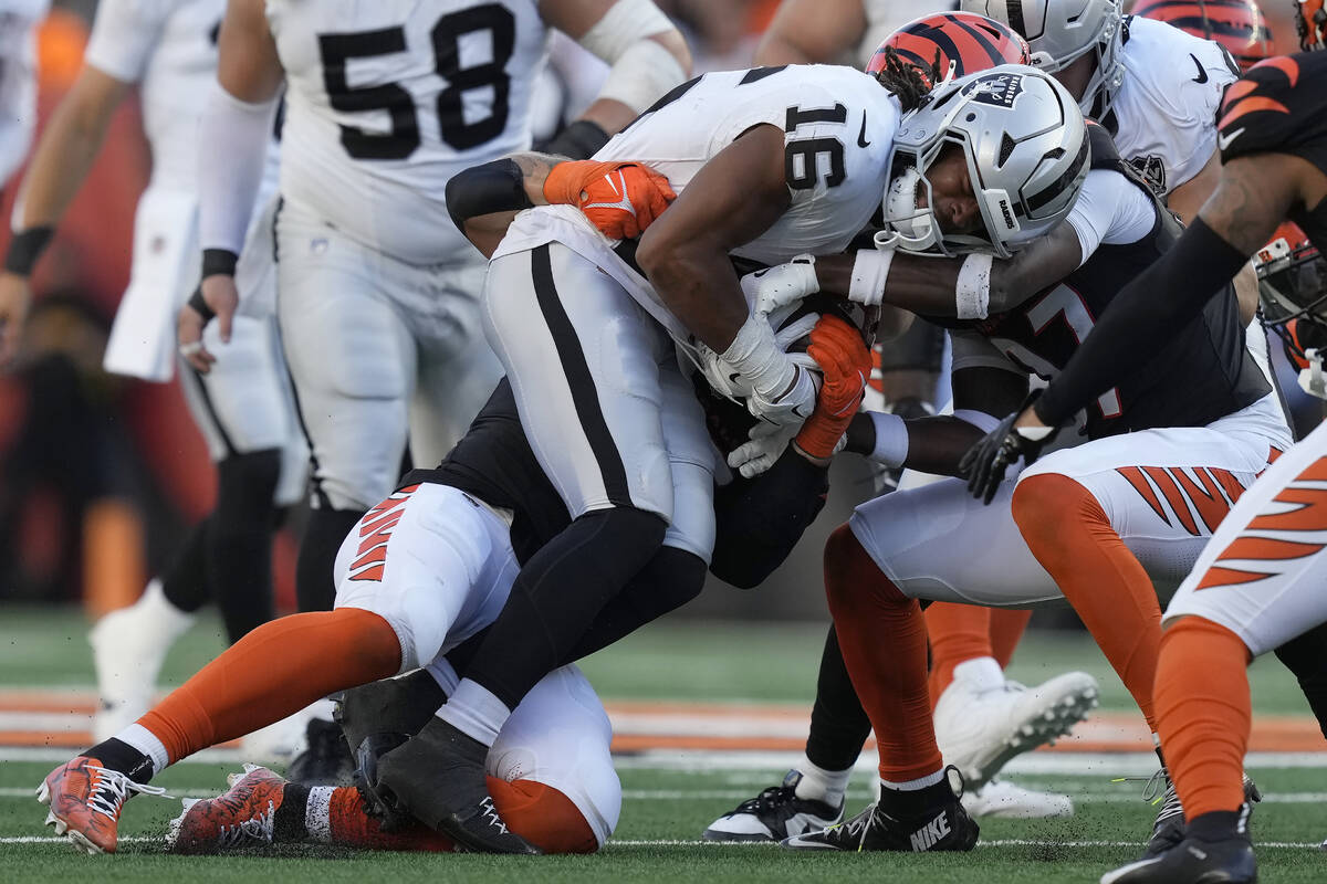 Las Vegas Raiders wide receiver Jakobi Meyers (16) is tackled by Cincinnati Bengals players dur ...