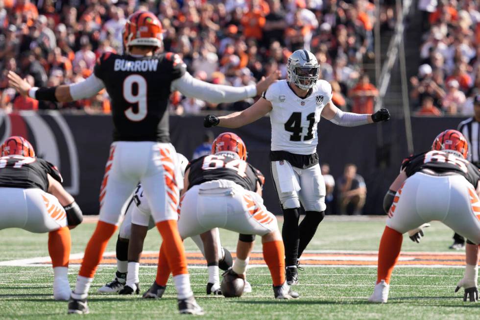 Cincinnati Bengals quarterback Joe Burrow (9) and Las Vegas Raiders linebacker Robert Spillane ...