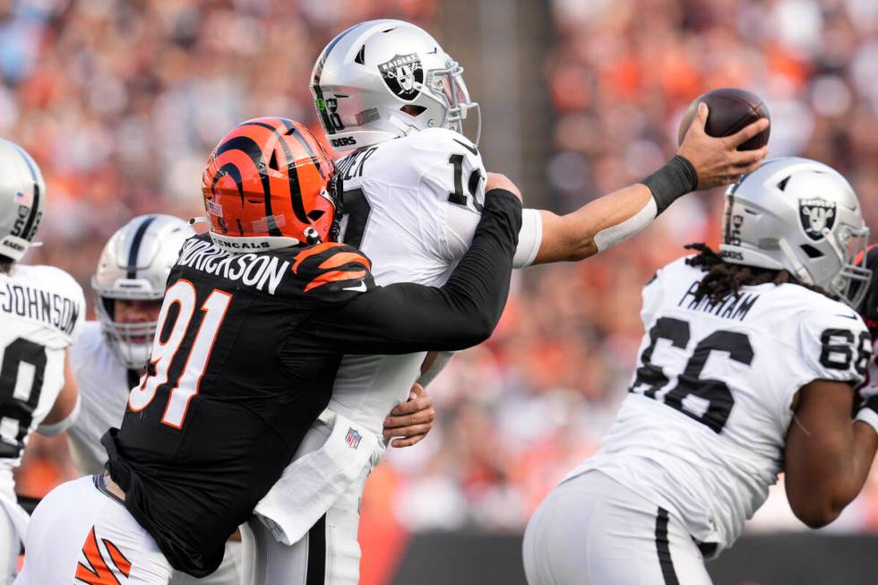 Cincinnati Bengals defensive end Trey Hendrickson, left, sacks Las Vegas Raiders quarterback De ...