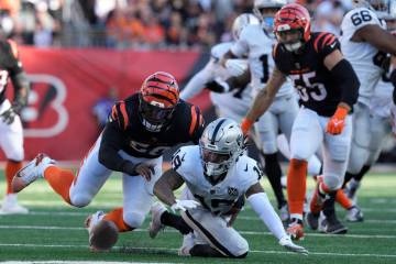 Las Vegas Raiders wide receiver DJ Turner, bottom, tries to recover a fumble by quarterback Gar ...