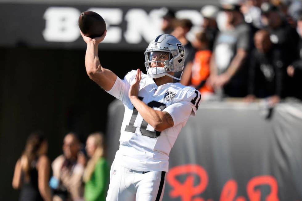 Las Vegas Raiders quarterback Desmond Ridder warms up before an NFL football game against the C ...