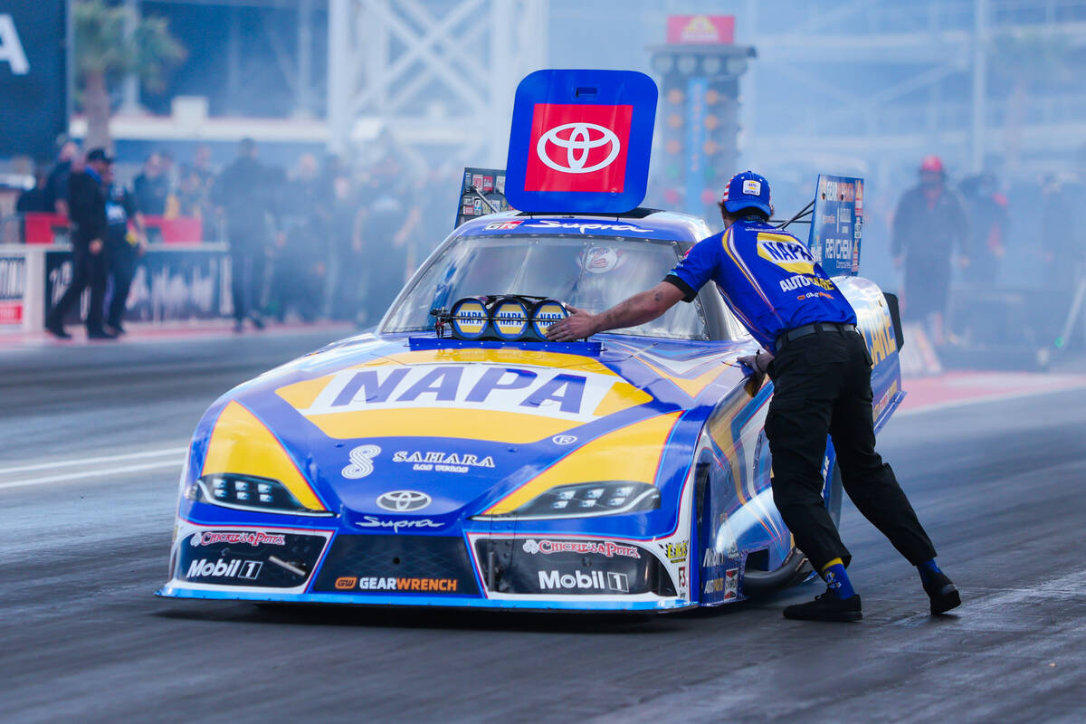 NHRA driver Ron Capps’ car is checked before a race during the NHRA Funny Car quarterfin ...