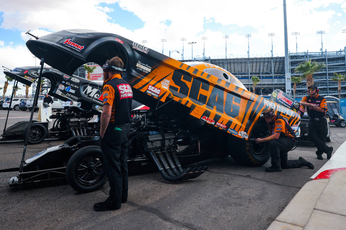 NHRA driver Dan Wilkerson’s car is worked on by his crew during the NHRA Funny Car quart ...