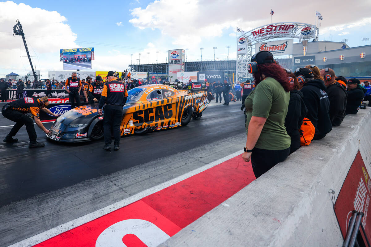 NHRA driver Dan Wilkerson’s car is worked on by his crew during the NHRA Funny Car quart ...