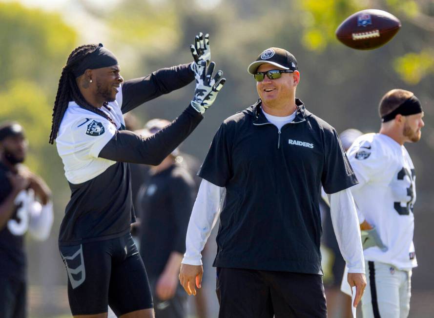 Raiders wide receiver Davante Adams (17) looks in a pass as he hangs out with offensive coordin ...