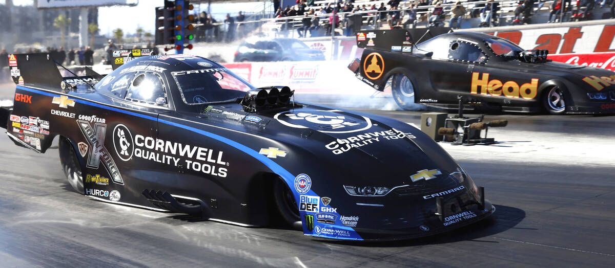 Funny car drivers Austin Prock, left, and Blake Alexander take off during the semifinals of the ...