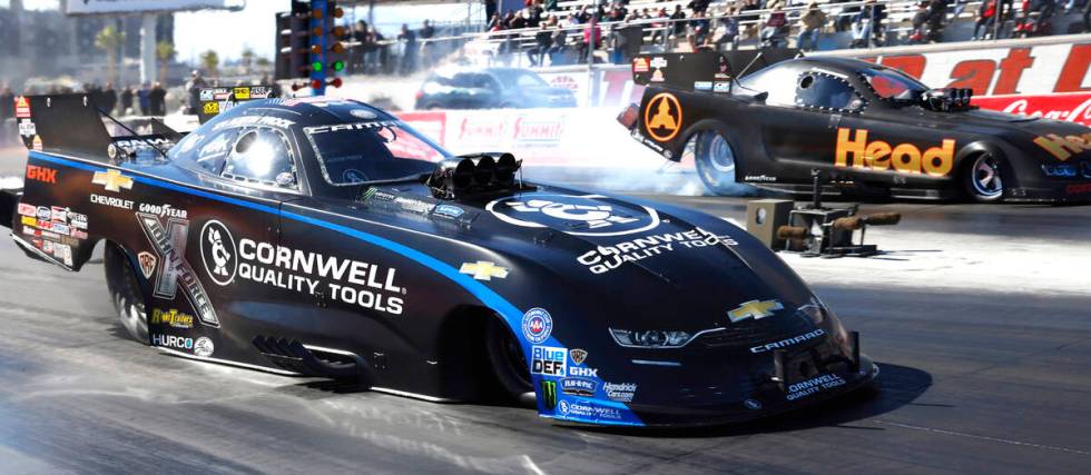 Funny car drivers Austin Prock, left, and Blake Alexander take off during the semifinals of the ...