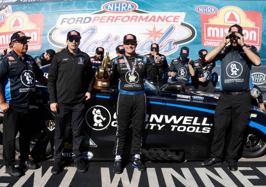 Funny car driver Austin Prock, right, celebrates his win following the NHRA Nationals at the St ...