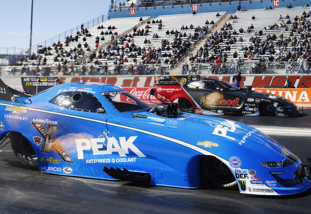 Funny car drivers Jack Beckman, left, and Paul Lee take off during the semifinals of the NHRA N ...