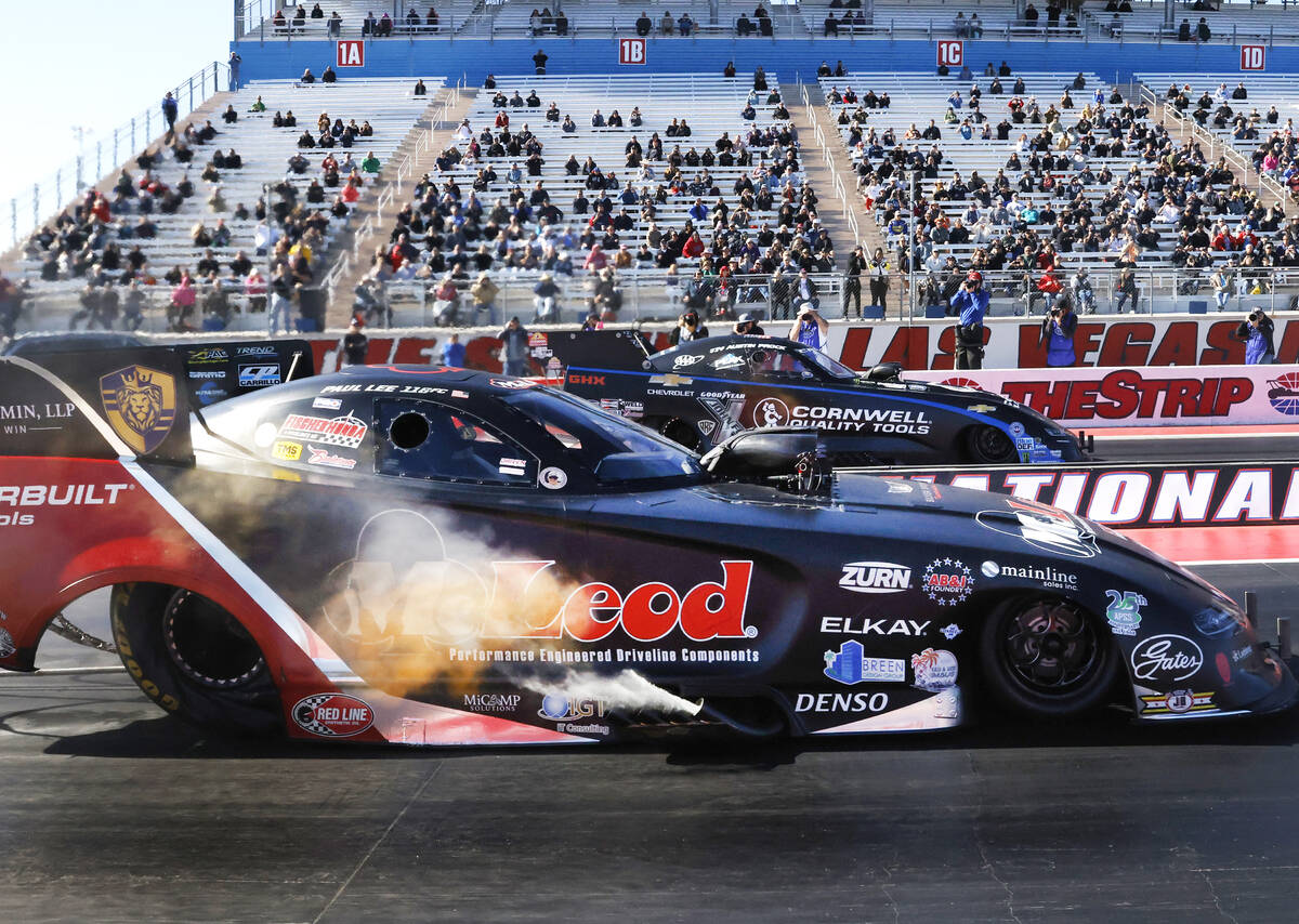 Top Fuel drivers Paul Lee, left, and Austin Prock take off during the final of the NHRA Nationa ...