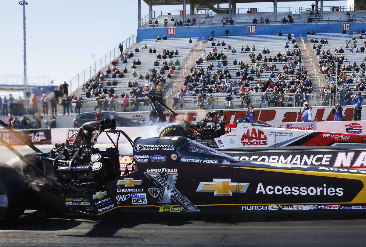 Top Fuel drivers Brittany Force, left, and Doug Kalitta take off during the final of the NHRA N ...