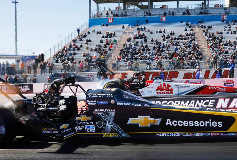 Top Fuel drivers Brittany Force, left, and Doug Kalitta take off during the final of the NHRA N ...