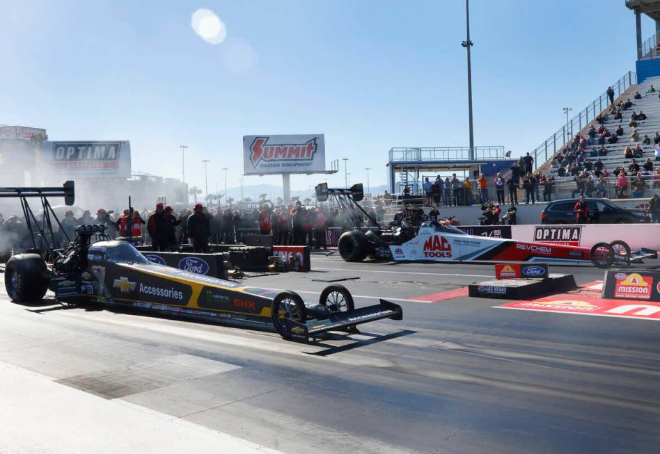 Top Fuel drivers Brittany Force, left, and Doug Kalitta take off during the final of the NHRA N ...