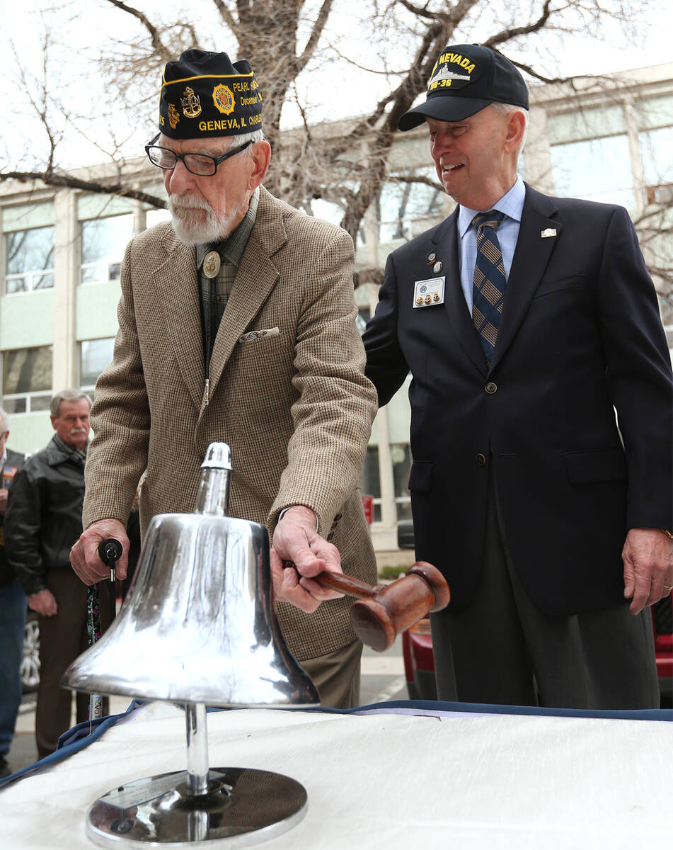 Pearl Harbor survivor Charles Sehe, left, rings the USS Nevada ship's bell in honor of his ship ...