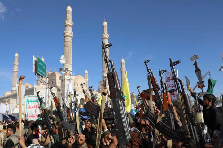 Houthi supporters raise their machine guns during an Anti- U.S and Israel rally in Sanaa, Yemen ...