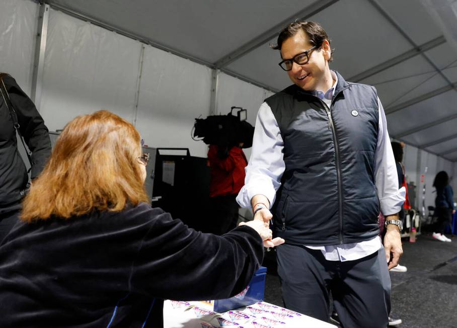 Nevada Secretary State Cisco Aguilar shakes hands with poll worker Esmeralda Reynold during pri ...