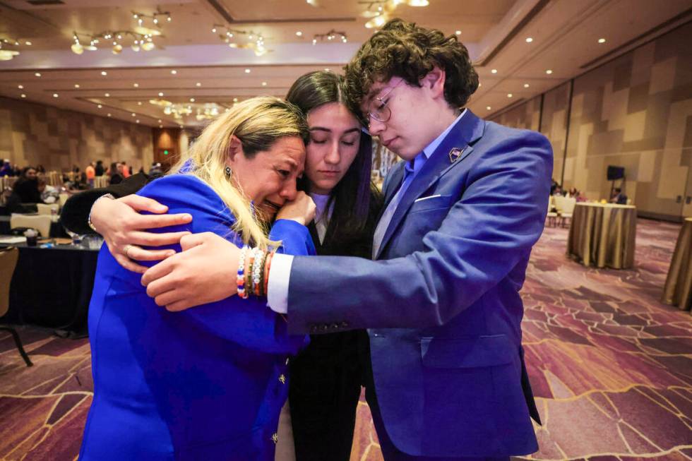 Carolyn Salvador Avila, middle, hugs and comforts her mom, Carolina, and brother, Julian, as re ...