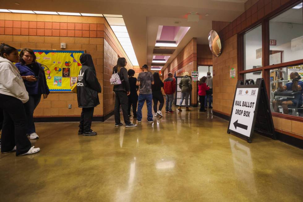 Voters line up to cast their ballots on Election Day evening at the Cambridge Recreation Center ...