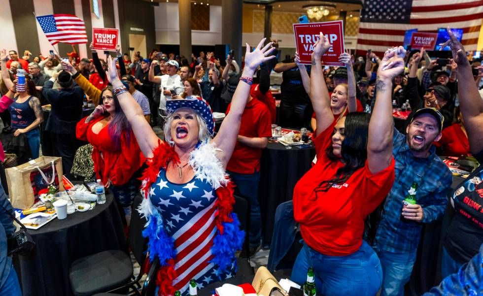 Supporters Stephanie Smith and Lamesha Young celebrate with others as Donald Trump is re-electe ...