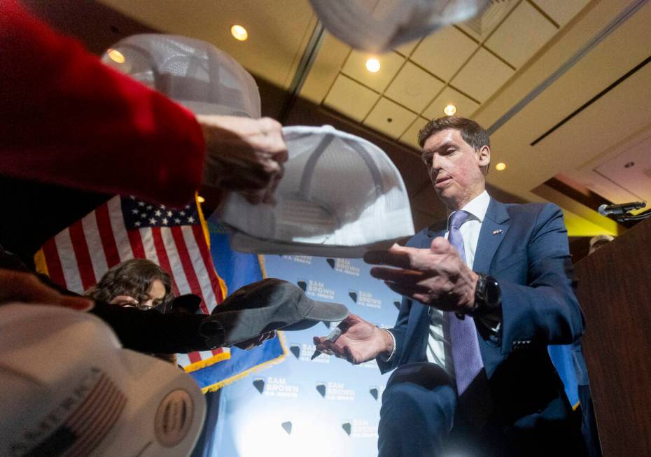 Republican senatorial candidate Sam Brown signs hats after giving a celebratory speech during h ...