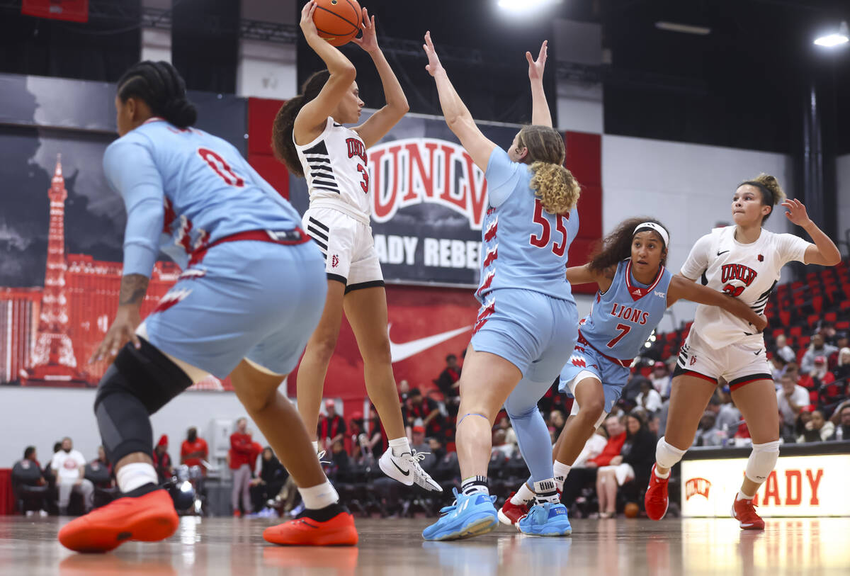 UNLV Lady Rebels guard Kiara Jackson (3) looks to pass the ball under pressure from Loyola Mary ...