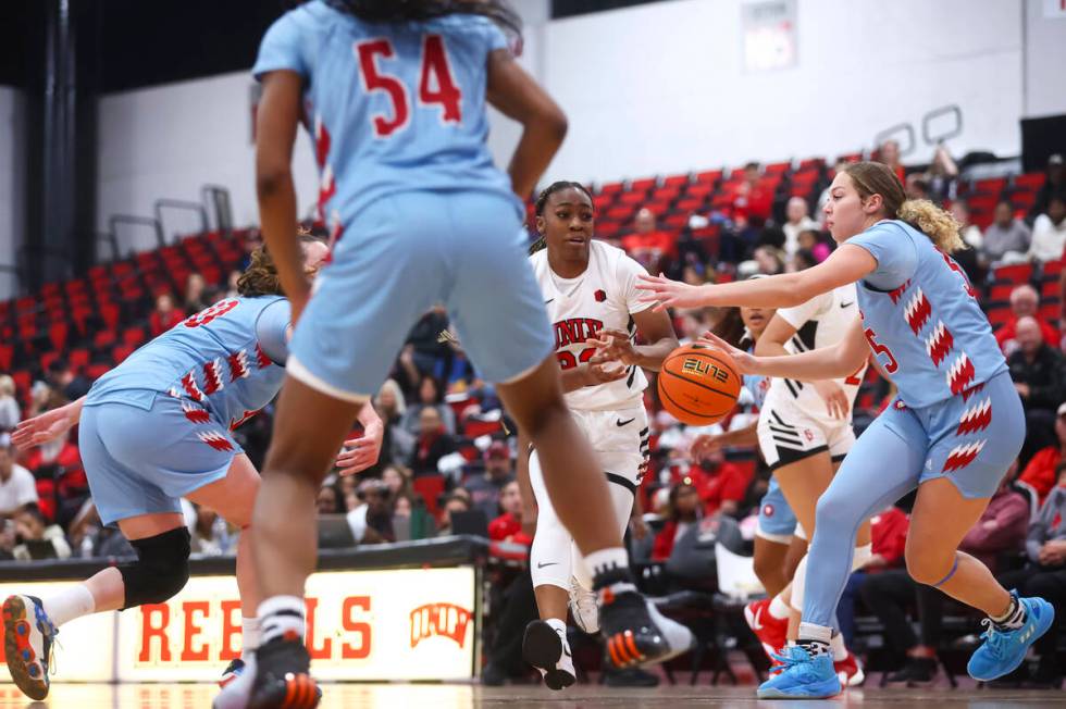 UNLV Lady Rebels guard Amarachi Kimpson (33) passes the ball under pressure from Loyola Marymou ...