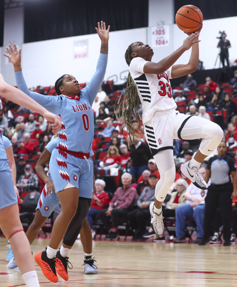 UNLV Lady Rebels guard Amarachi Kimpson (33) lays up the ball in front of Loyola Marymount Lion ...