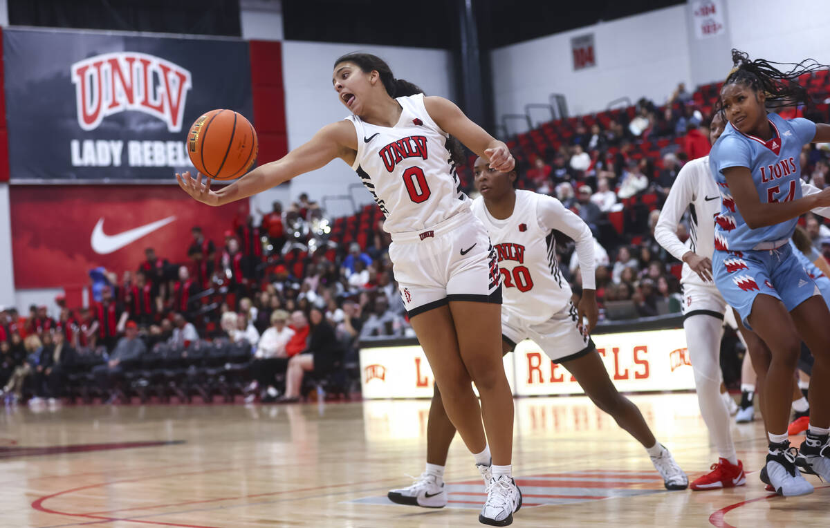 UNLV Lady Rebels guard Teagan Colvin (0) reaches for a rebound during the first half of a baske ...